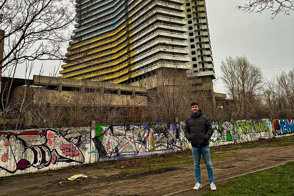 Ballyferriter native Tomás Mac An T-Saoir pictured outside the an unfinished 20th-century Parus Hotel in the city of Dnipro in Ukraine.